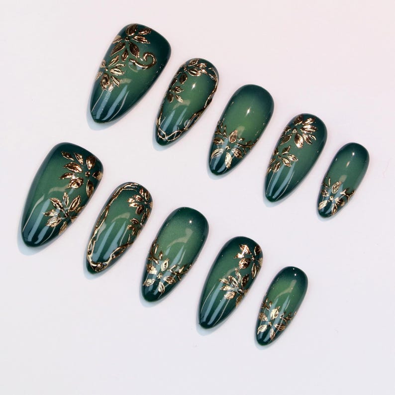 Set of green nail art designs with gold floral patterns on a white background