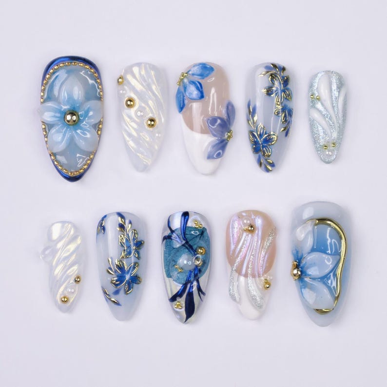 Aurora iridescent glitter swirl press-on nails with gold pearl bead accent on almond shape