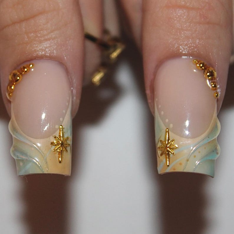 Set of 10 handcrafted coffin press-on nails with iridescent 3D flowers and gold celestial charms