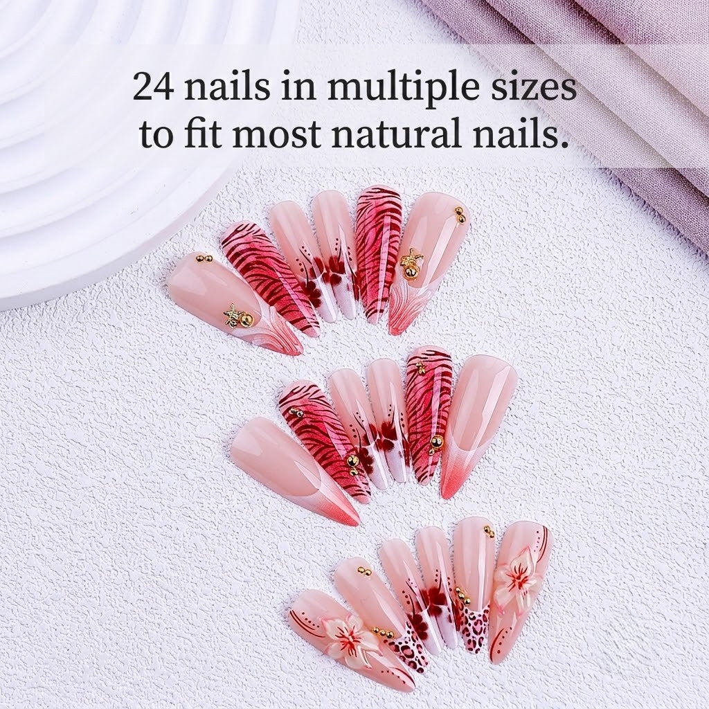 A close-up of 24pcs JRNAIL long pointy press-on nails decorated with cherry blossoms, tiger stripes, and leopard patterns with crystals and makeup brushes nearby.
