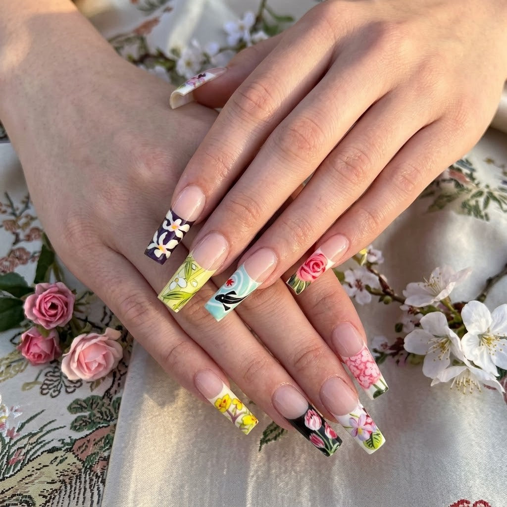 A close-up shot of a manicured hand wearing the JRNAIL Oriental Artistic-style medium square press-on nails. The glossy nails clearly display the intricate traditional art, including a geisha portrait line drawing, a red koi fish, and blooming floral designs, showing how they look when applied to natural nails