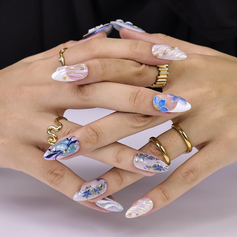 Luxury mixed almond press-on nail set with watercolor blue floral art and gold outline detail