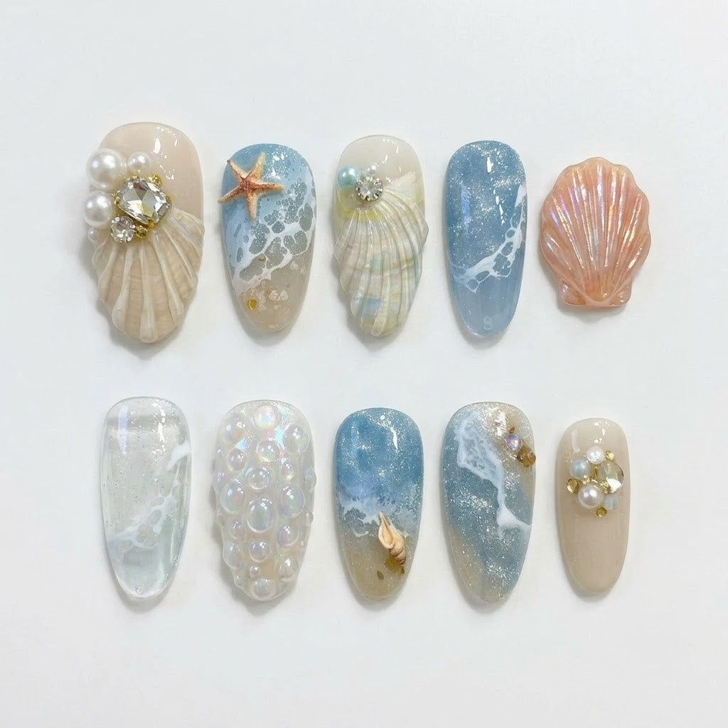 Beach-inspired false nails with 3D ocean waves, pearlescent shells, and starfish accents, showcasing a full 30-piece multi-size set for natural nails.