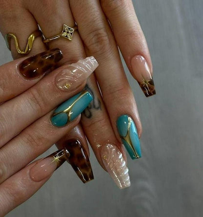 Turquoise blue coffin press-on nail with bold gold vein line art on glossy base