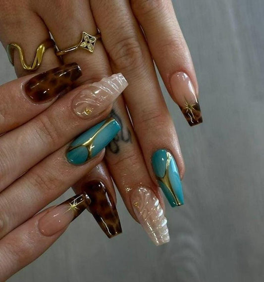 Turquoise blue coffin press-on nail with bold gold vein line art on glossy base